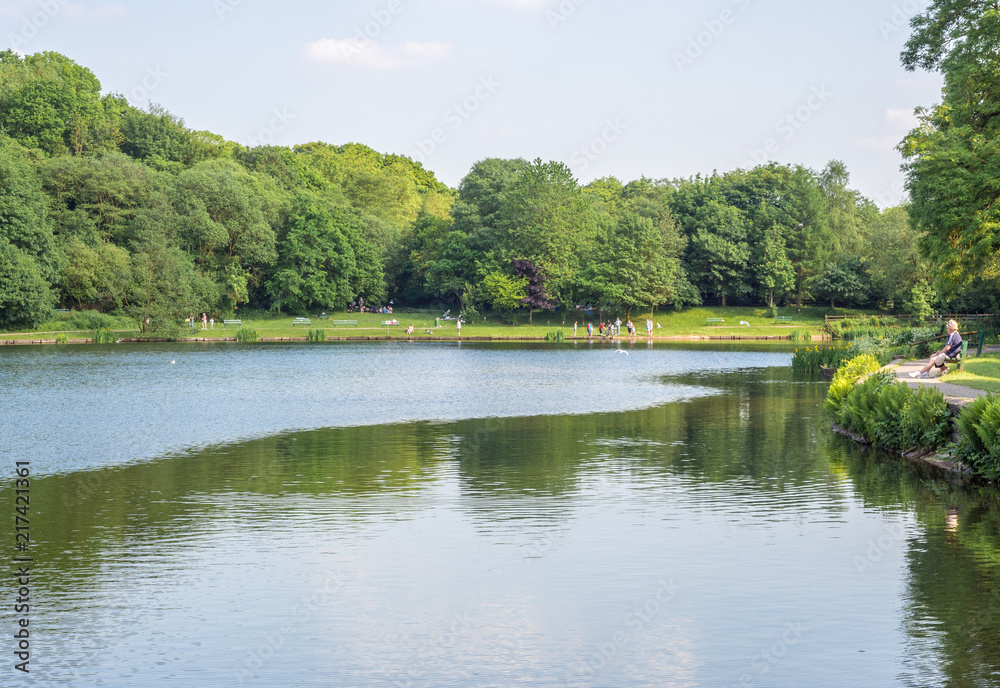 Visitors to Yarrow Valley Country Park enjoying the peace and quiet on a beautiful summers afternoon, Chorley, Lancashire, Uk
