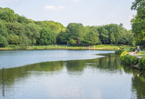 Visitors to Yarrow Valley Country Park enjoying the peace and quiet on a beautiful summers afternoon  Chorley  Lancashire  Uk