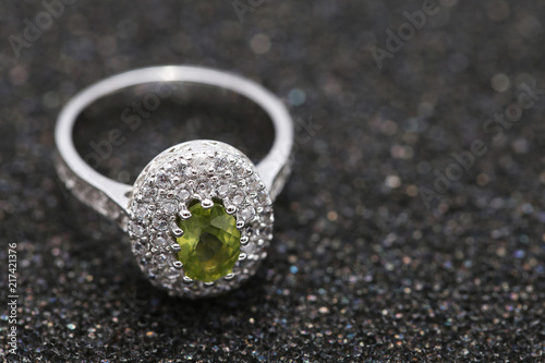 Fototapeta Naklejka Na Ścianę i Meble -  green gem stone on diamond ring