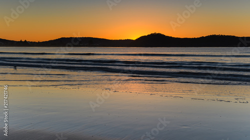 Orange Glow Sunrise Seascape and Mountain Silhouettes
