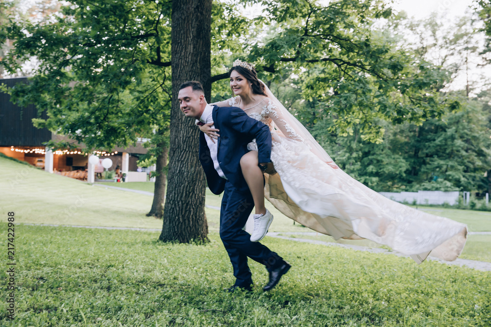 Fototapeta premium Newlyweds dance and have fun outdoors.