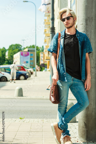 Hipster man standing on city street, urban fashion