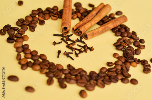 Wallpaper Mural coffee beans in a circle with cinnamon and clove on a yellow background with a place under the text Torontodigital.ca