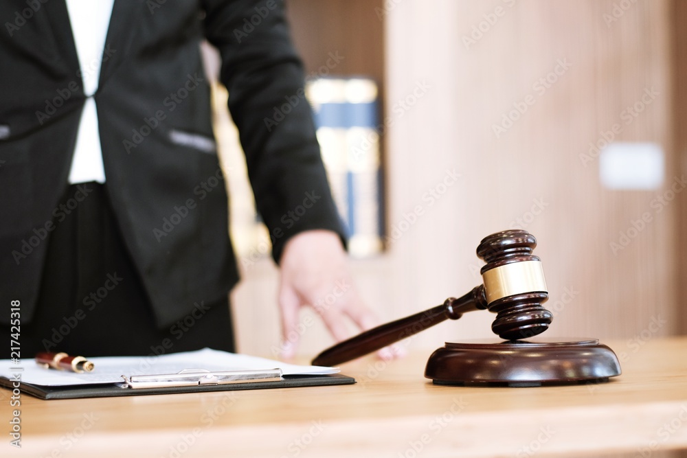 Legal counsel presents to the client a signed contract with gavel and legal law. justice and lawyer concept. Legal counsel presents to the client a signed contract with gavel and legal law. justice and lawyer concept.