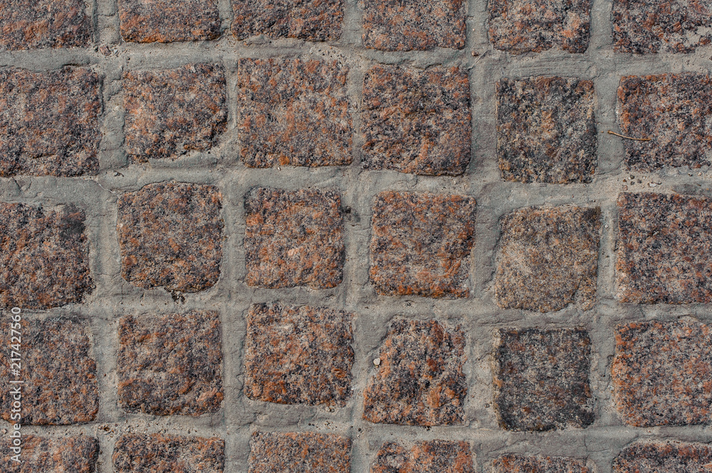 Top background macro photography of brown stone block road pavement Top background macro photography of brown stone block road pavement