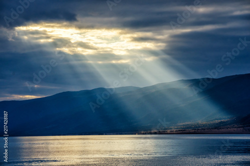 Sun shining through thick cloudy sky, silver lining