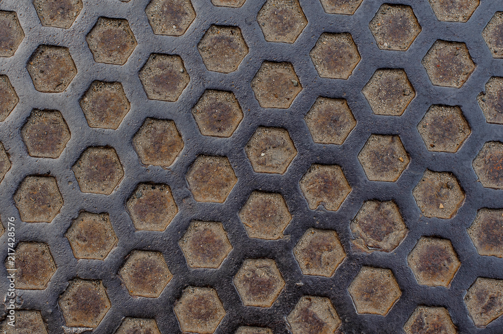 Macro ba kground of metal grid in shape of cells on ground