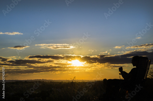 man drinking beer at sunset © Алексей Филатов