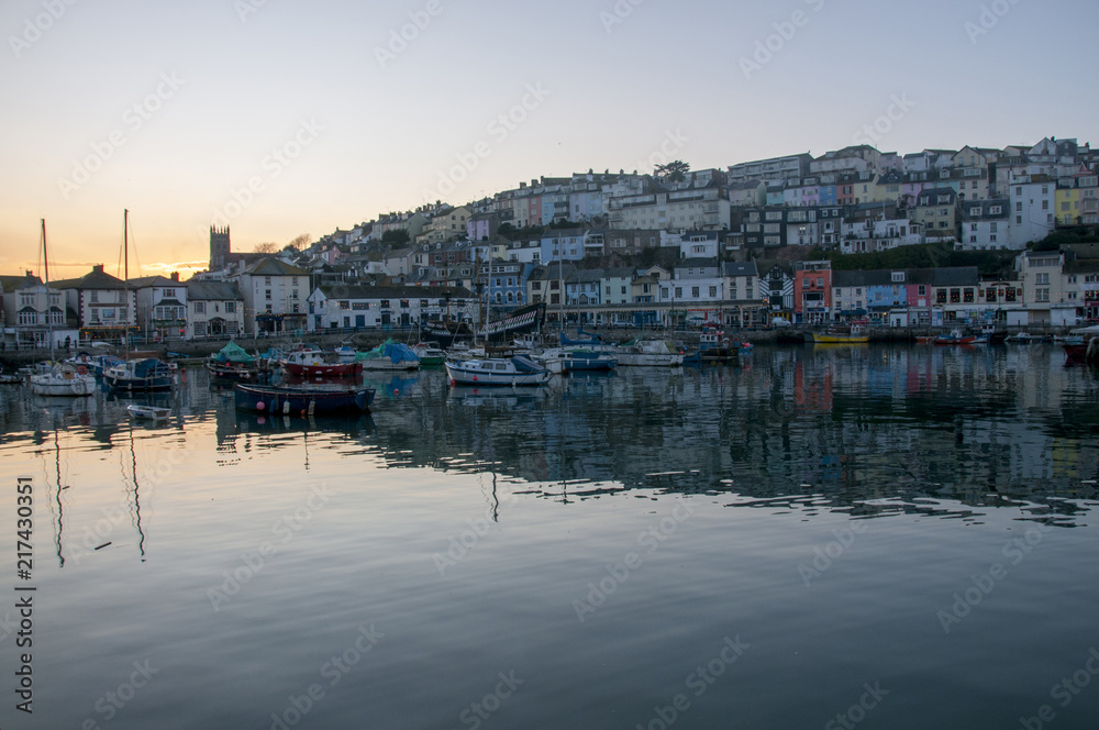 Small boats in Brixham Harbour as sun sets