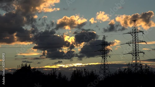 High voltage transmission power line at nature landscape by sunset. photo