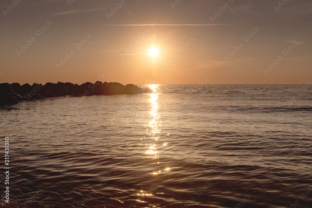 Fototapeta premium Watching a beautiful evening sunset from the beach is a great summer holidays. Lonstrup in North Jutland in Denmark, Skagerrak, North Sea