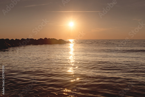 Watching a beautiful evening sunset from the beach is a great summer holidays. Lonstrup in North Jutland in Denmark, Skagerrak, North Sea photo