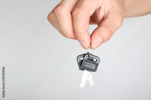 key in hand on a light background