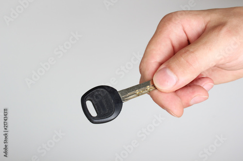 key in hand on a light background © sergeylapin