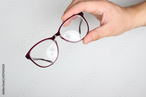 glasses in hand on a light background