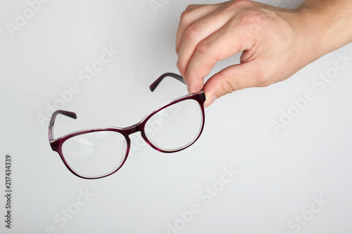 glasses in hand on a light background