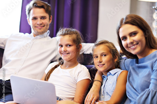 Happy family relaxing in hotel room