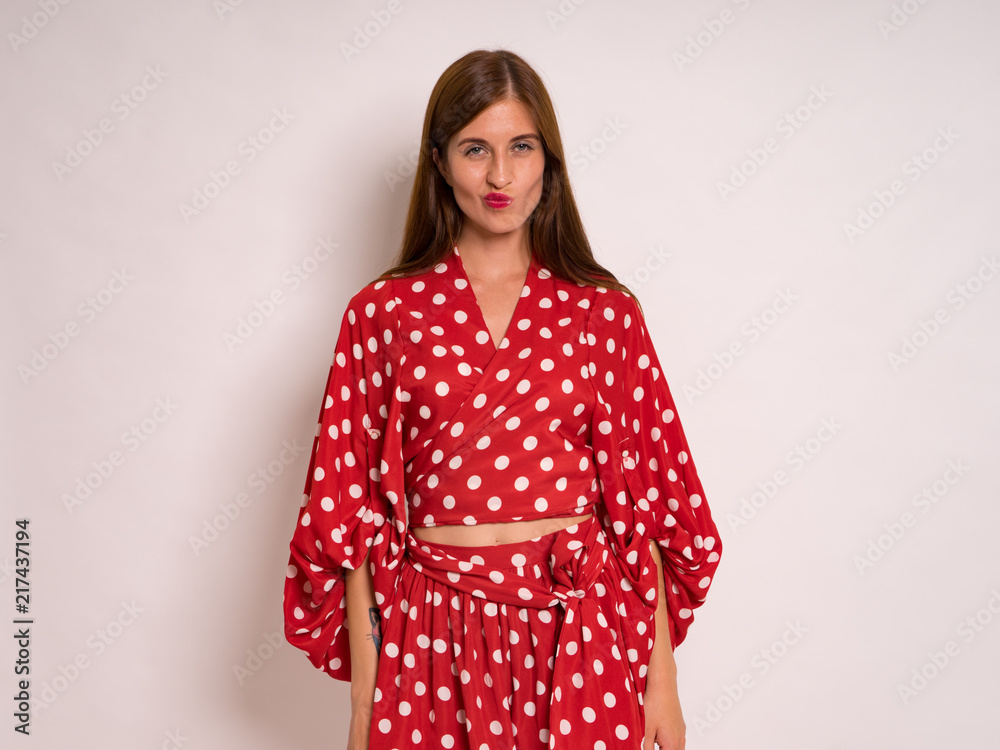 female Model Against white Studio Background in red dress female Model Against white Studio Background in red dress