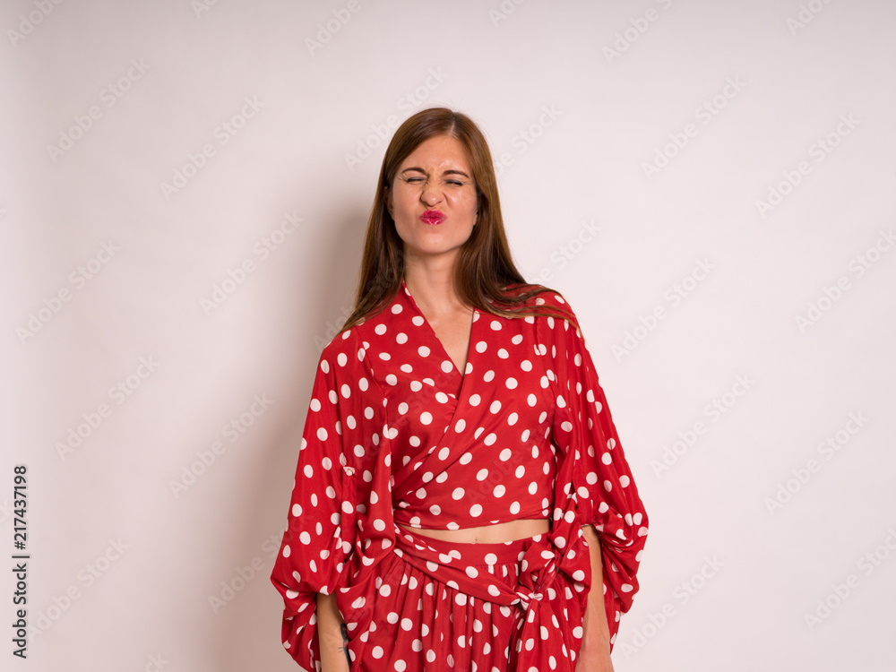 female Model Against white Studio Background in red dress female Model Against white Studio Background in red dress