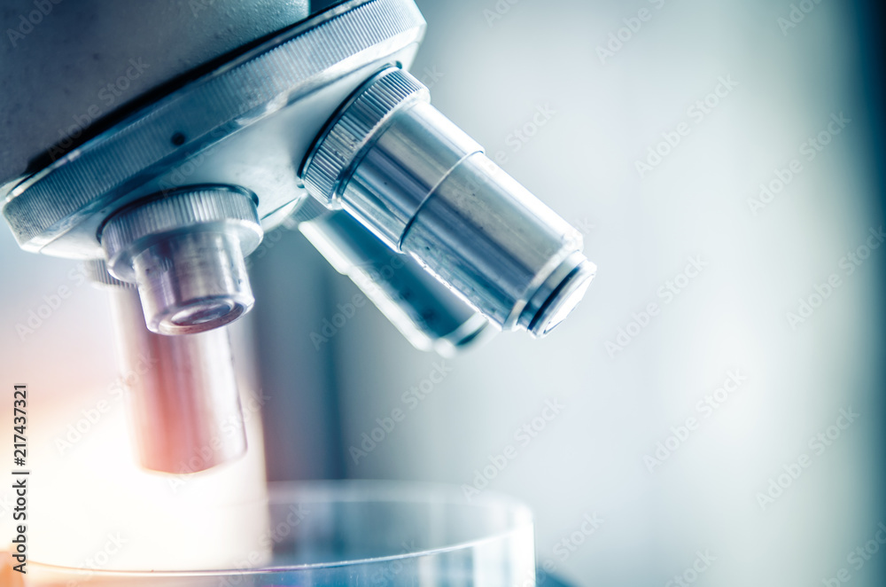 Close-up shot of microscope with metal lens at laboratory. Scientific and healthcare research background. Close-up shot of microscope with metal lens at laboratory. Scientific and healthcare research background.