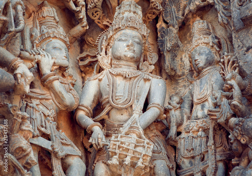 Fragment of stone carved relief with musicians playing music of gods. 12th century South Indian temple. Halebidu heritage, India