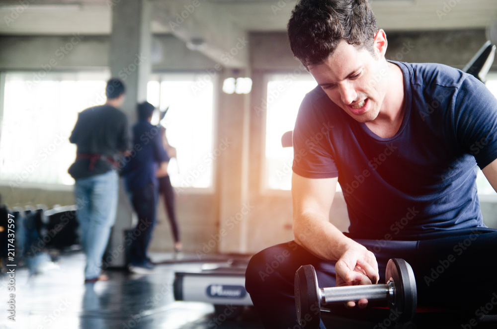 Bodybuilder working out with dumbbell weights at the gym Bodybuilder working out with dumbbell weights at the gym