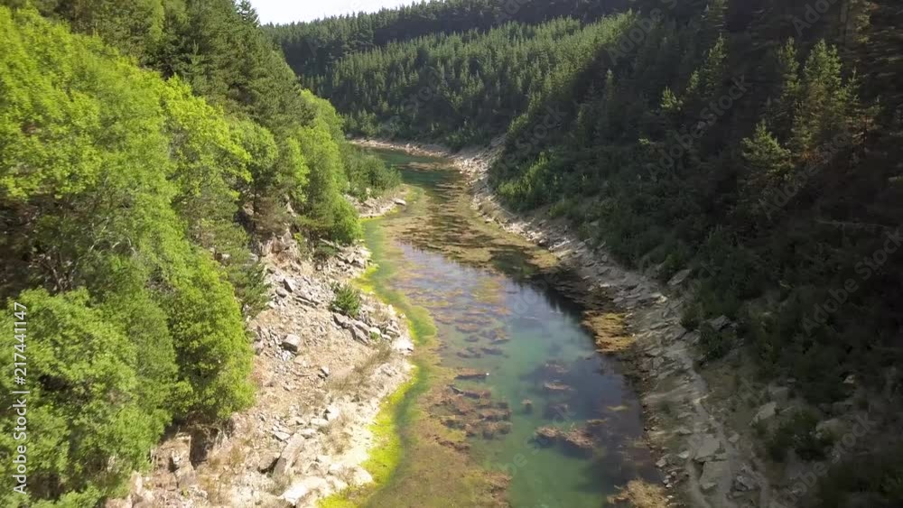Aerial drone view flying over a long, narrow lake located in a tree lined canyon in Wales Aerial drone view flying over a long, narrow lake located in a tree lined canyon in Wales