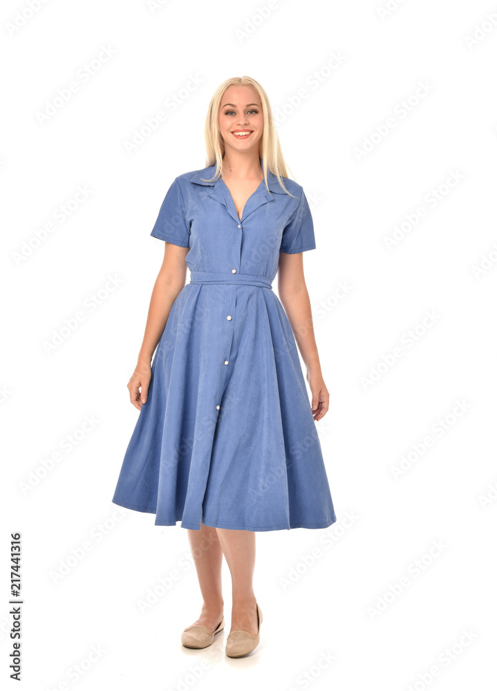 full length portrait of blonde girl wearing blue dress. standing pose. isolated on white studio background. full length portrait of blonde girl wearing blue dress. standing pose. isolated on white studio background.