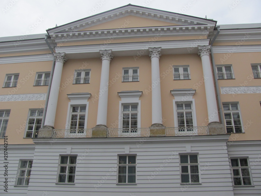 Yellow building with white columns, fragment, architecture of Russian classicism