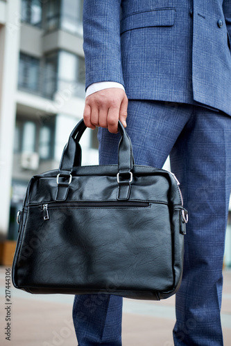 Businessman style. Men style. Young businessman with bag
