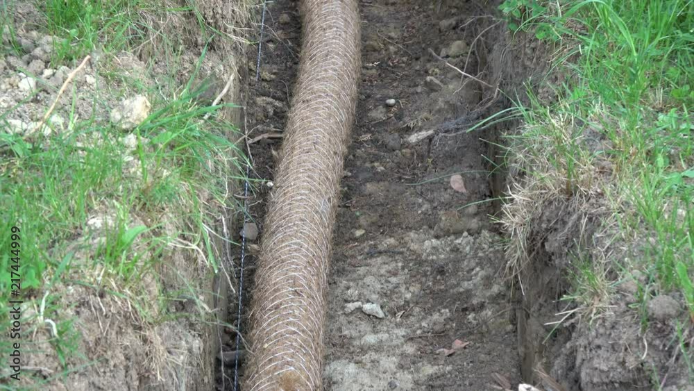 drainage trench with pipe on field
drainage trench with pipe on field