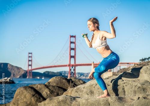 Woman doing yoga on the beach