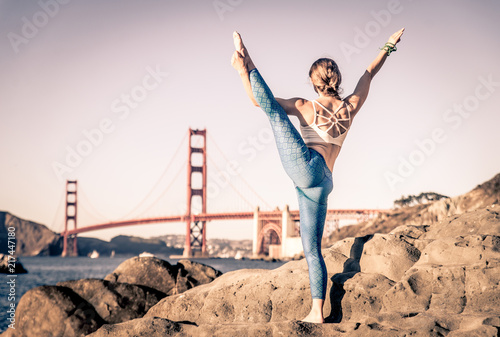 Woman doing yoga on the beach