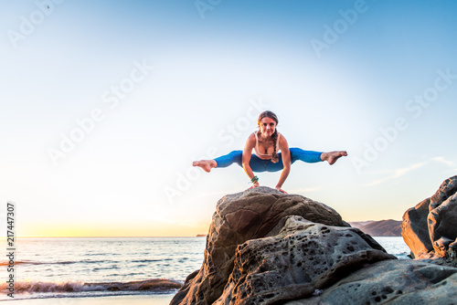 Woman doing yoga on the beach