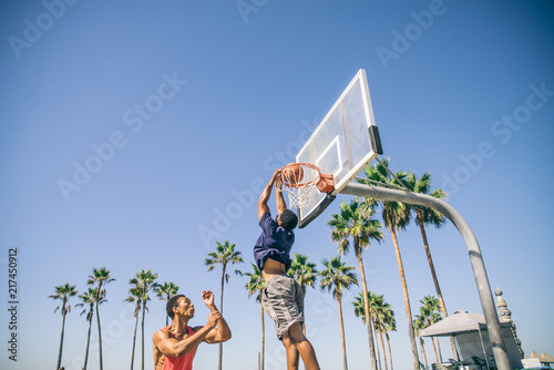 Friends playing basketball © oneinchpunch