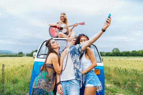 Happy friends driving a vintage minivan © oneinchpunch