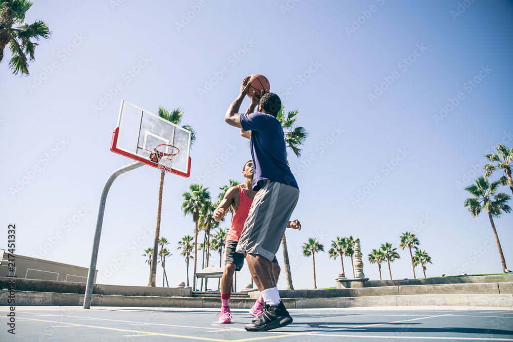 Fototapeta premium Friends playing basketball