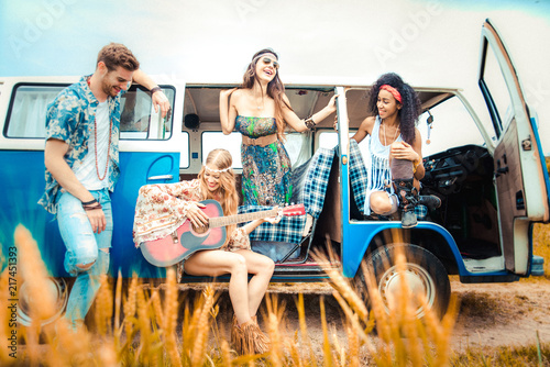 Fotografia Happy friends driving a vintage minivan