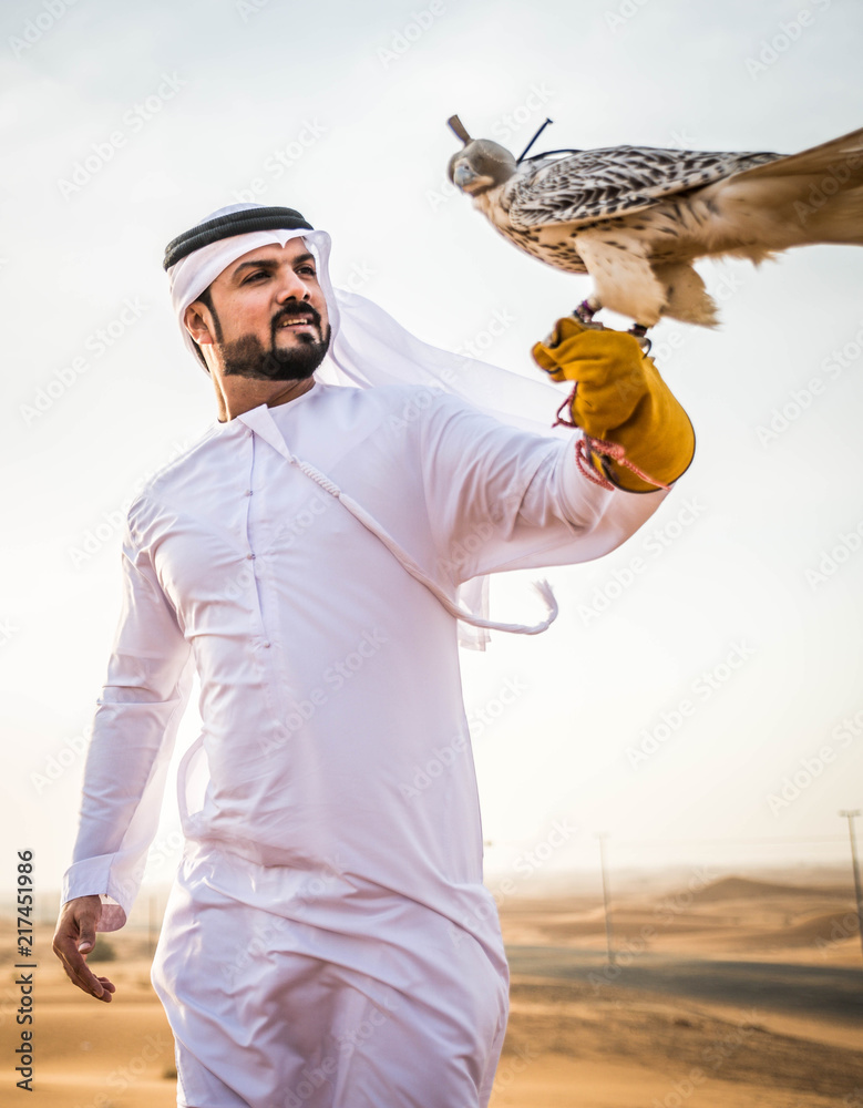 Arabic man in the desert with his hawk Stock Photo Adobe Stock
