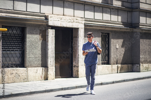 Young and modern business man crossing the street