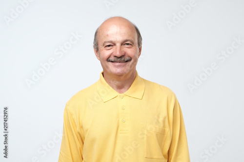 Portrait of mature european man looking at camera and smiling. © Viktor Koldunov