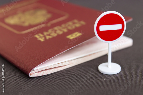 Photography Stop illegal migration concept, Russian passport and stop sign close up