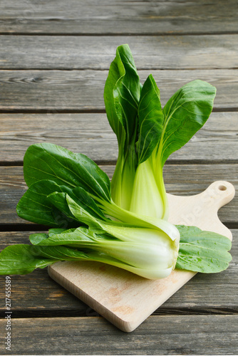 Bio Bok choi or Choy with water drop on wooden broad and wooden floor.
Green leafy vegetable.