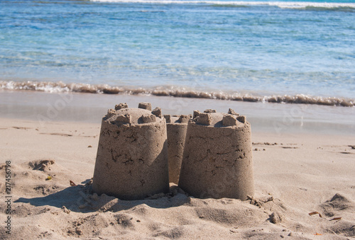 Three towers of sandy castle on the beach