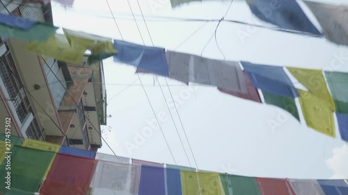 Traditional colorful buddhism prayer flags over over street in Kathmandu, Nepal photo