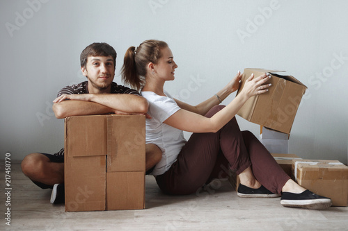 Young cute couple just married sitting on floor © olgasparrow