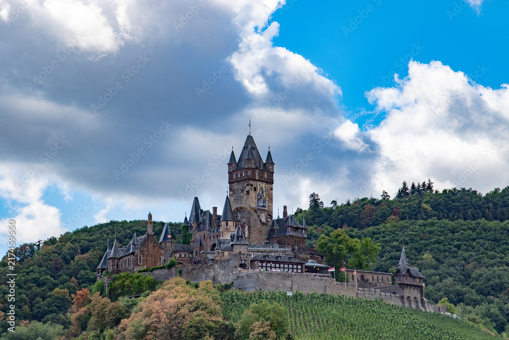 Historical castle of cochem in germany under blue sky with big clouds in summer