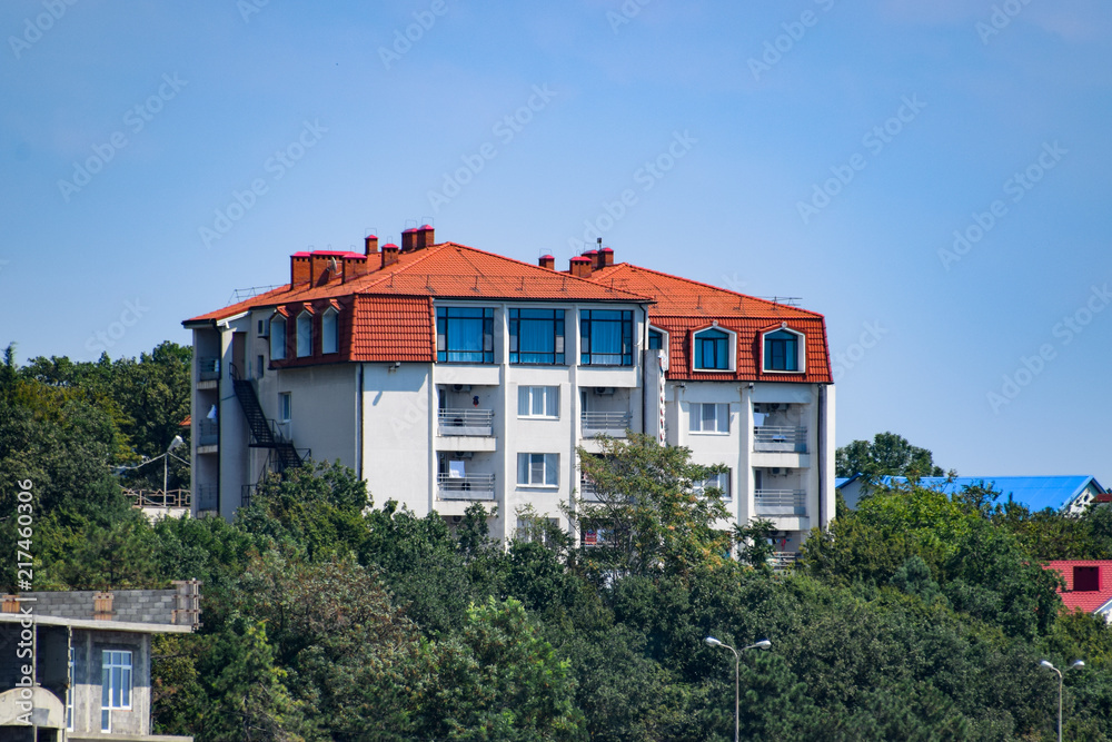 A multi-storey house on a mountain. Hotel for holidaymakers.