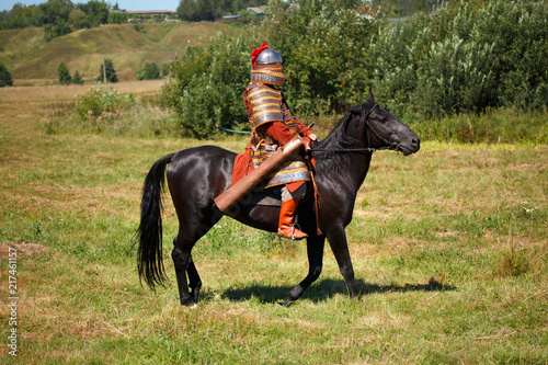 Reconstruction. Medieval armored knight on horse. Soldier in historical costume. Hhistorical reenactor