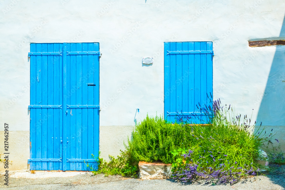 Typical medieval house with blue doors and window and lavender flowers in pots in Provence, Verdon in France Typical medieval house with blue doors and window and lavender flowers in pots in Provence, Verdon in France